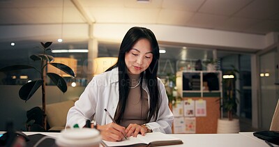 Buy stock photo Asian woman, writing or night with book for project planning, business course or deadline at office desk. Female person, journalist or copywriter taking notes in diary for education, reminder or idea