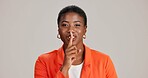 Black woman, portrait and finger silence in studio, confidential mystery and white background. Female person, shush and gesture for quiet communication, shut up and secret privacy or stop revelation