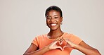 Heart hands, smile and love with portrait of black woman in studio for support, peace and pride. Solidarity, health and happiness with person from Kenya on white background for emoji icon and care