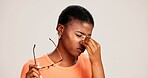 Glasses, tired and eye strain with black woman in studio for stress, vision fatigue and pain. Vertigo, anxiety and frustrated with person on white background for tension, pressure and migraine