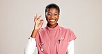 Doctor, woman and OK sign with portrait on studio background for healthcare success or medical excellence. Black person, happy or perfect emoji on mockup space for pediatric service or health support