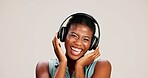 Portrait, woman and laughing with headphones on studio background for funny podcast, radio joke or enjoyment. Audio playlist, black person and happy with music, mockup space or streaming subscription