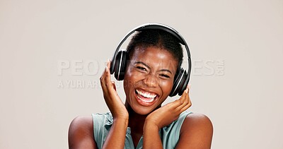 Buy stock photo Portrait, woman and laughing with headphones on studio background for funny podcast, radio joke or enjoyment. Audio playlist, black person and happy with music, mockup space or streaming subscription