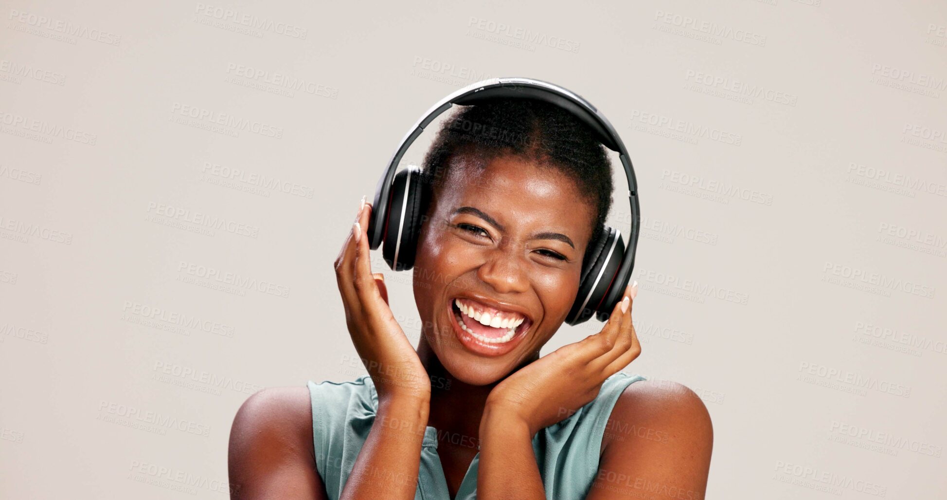 Buy stock photo Portrait, woman and laughing with headphones on studio background for funny podcast, radio joke or enjoyment. Audio playlist, black person and happy with music, mockup space or streaming subscription