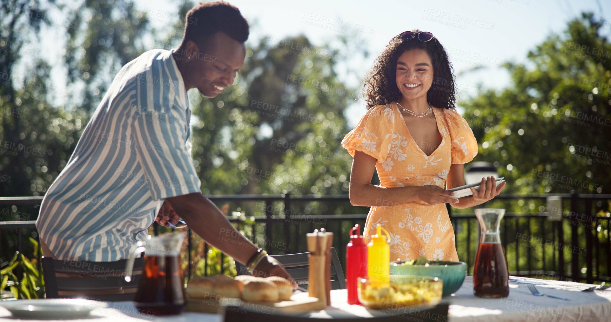 Buy stock photo People, friends and food at party for social, gathering or outdoor for New Years celebration. Woman host, man or serving lunch at event for reunion, sharing meal or bonding at table in holiday season