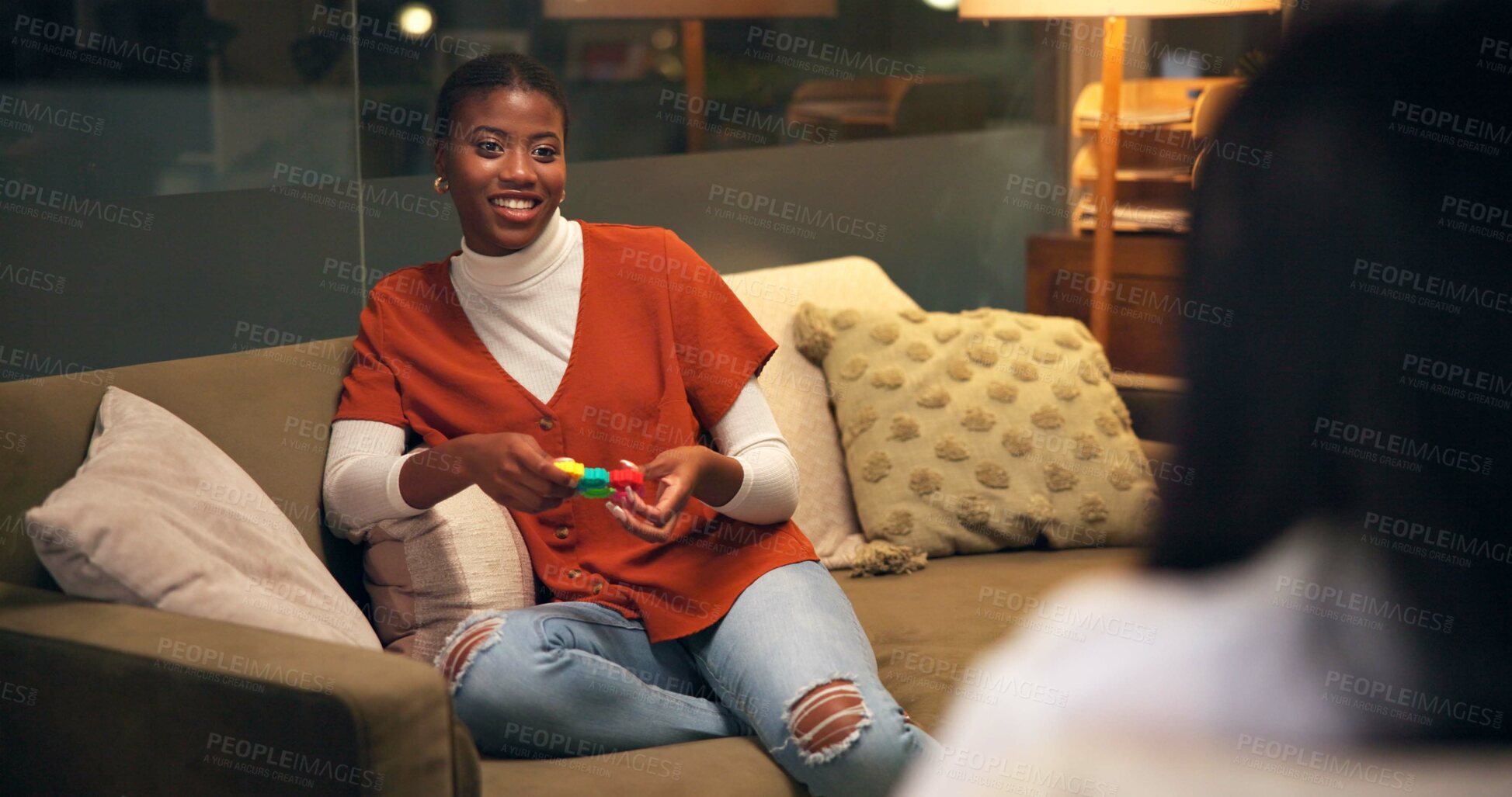 Buy stock photo Woman, psychologist and fidget in office for therapy, social development and healing at night. Happy client, therapist and support in late session for mental health, ADHD and toy for anxiety relief