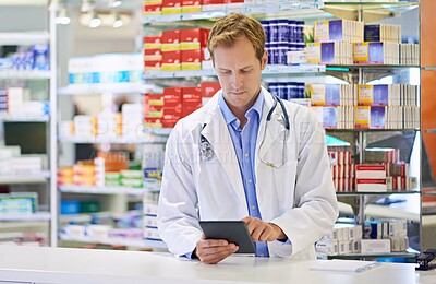 Buy stock photo Chemist, tablet and inventory for stock, checking and medicine in drugstore, pharmacy or health care. Male person, doctor and pharmaceuticals in dispensary for prescription, pills for info or advice