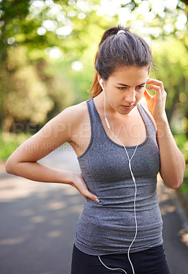 Buy stock photo Woman, thinking and fitness in nature with earphones, music and ready for exercise. Runner, relax and podcast in park for training advice, choosing song and playlist for wellness in Italy environment