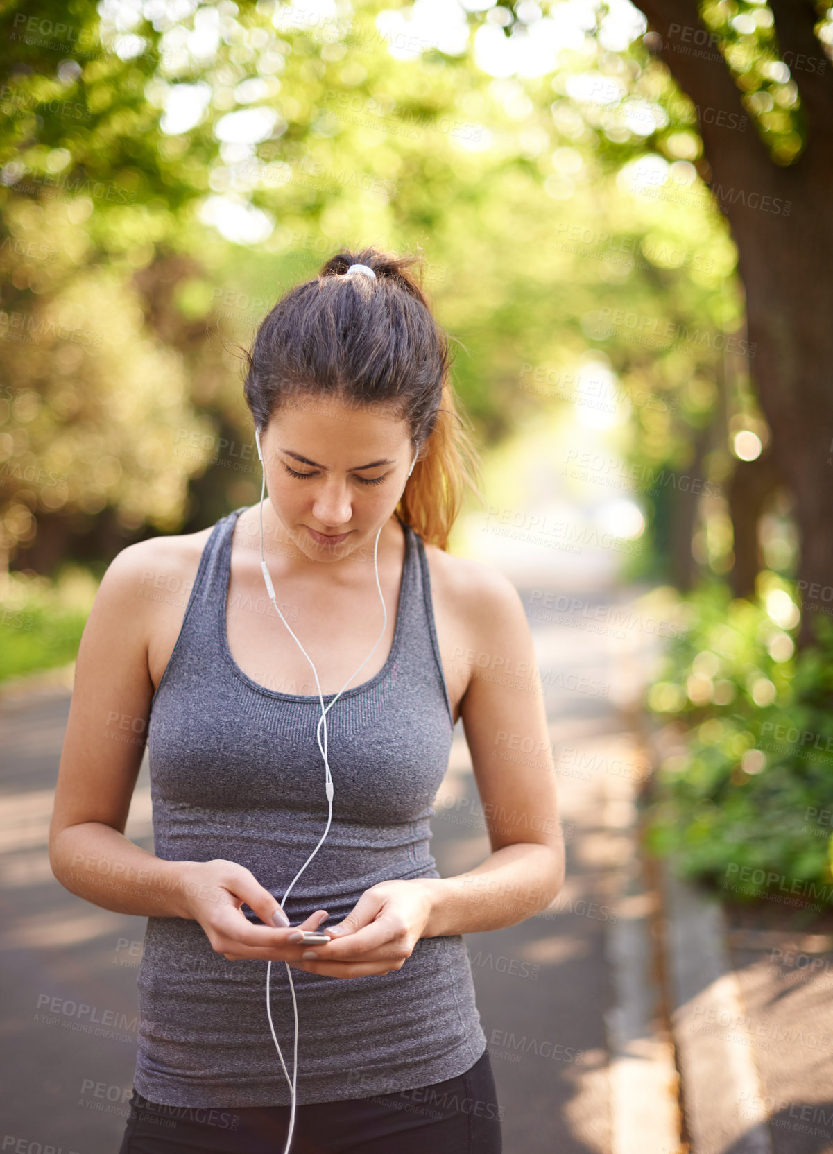 Buy stock photo Fitness, outdoor and woman with earphones, listening to music and motivation for exercise. Healthy person, runner and athlete in park, podcast and wellness with nature, radio and streaming audio