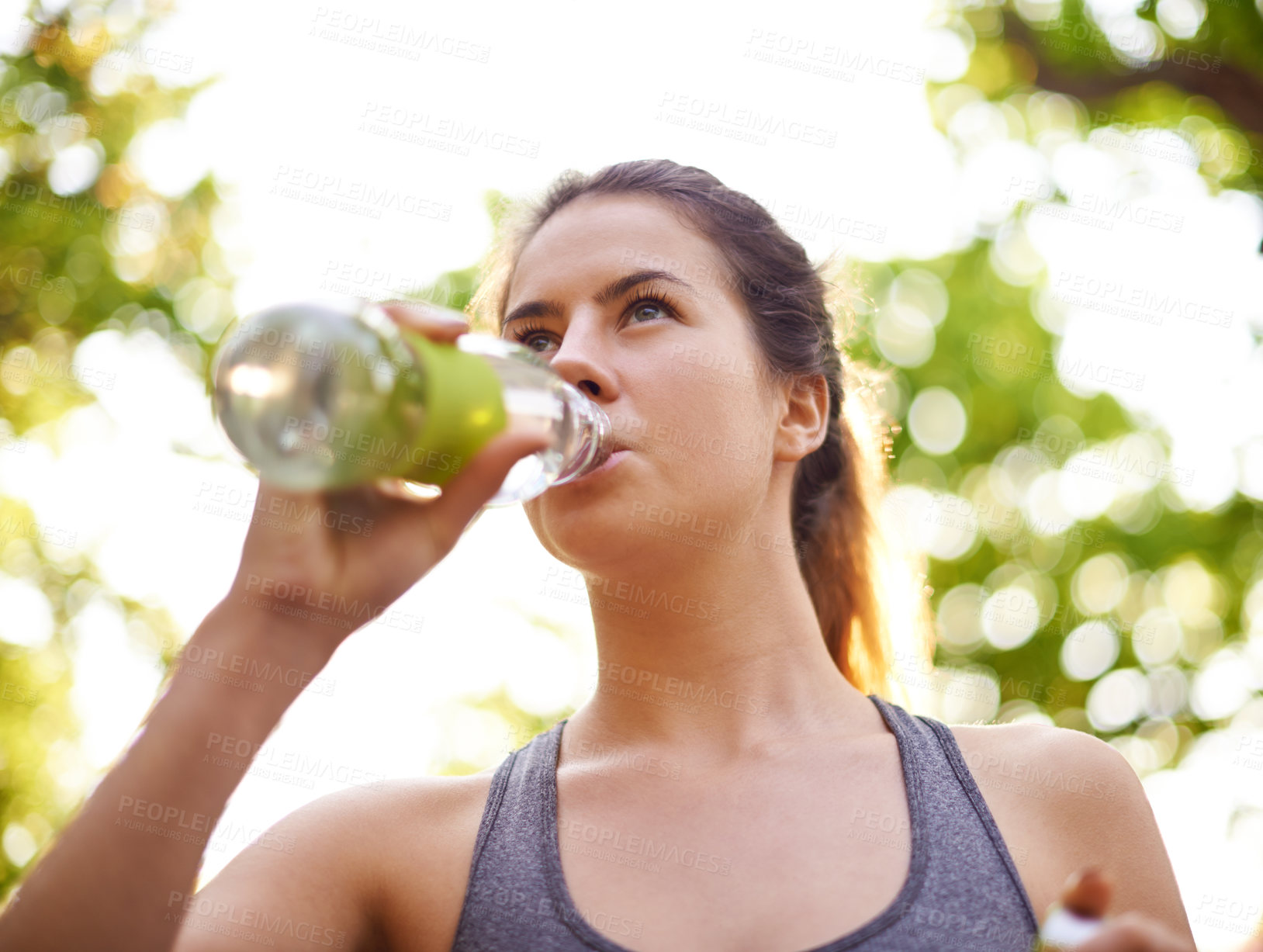 Buy stock photo Athlete, fitness and woman drinking water in nature for marathon training, exercise break and refresh from cardio. Runner, resting and mineral beverage outdoor for hydration, thirst and liquid diet