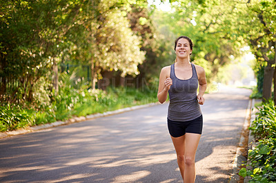 Buy stock photo Running, fitness and woman with training, energy and nature with challenge, wellness and endurance. Healthy person, outdoor or athlete with practice, cardio or workout with sports or runner in street