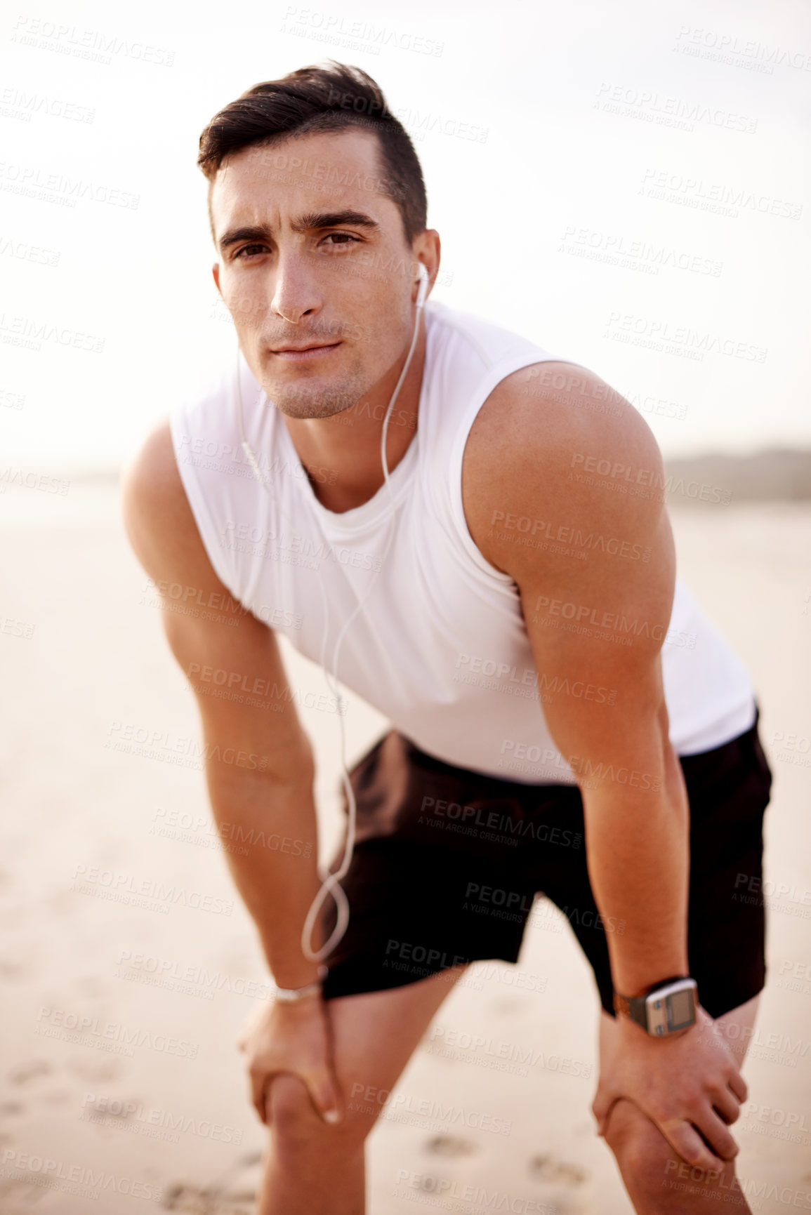 Buy stock photo Fitness, portrait and man on beach with earphones for streaming, outdoor workout and running in morning. Music, relax and runner at ocean with health, wellness and commitment to exercise in nature