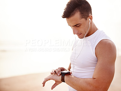 Buy stock photo Sports, beach and man with smart watch for tracking progress, bpm or heart rate activity with running. Fitness, digital timepiece and male athlete with equipment for cardio workout stats by ocean.