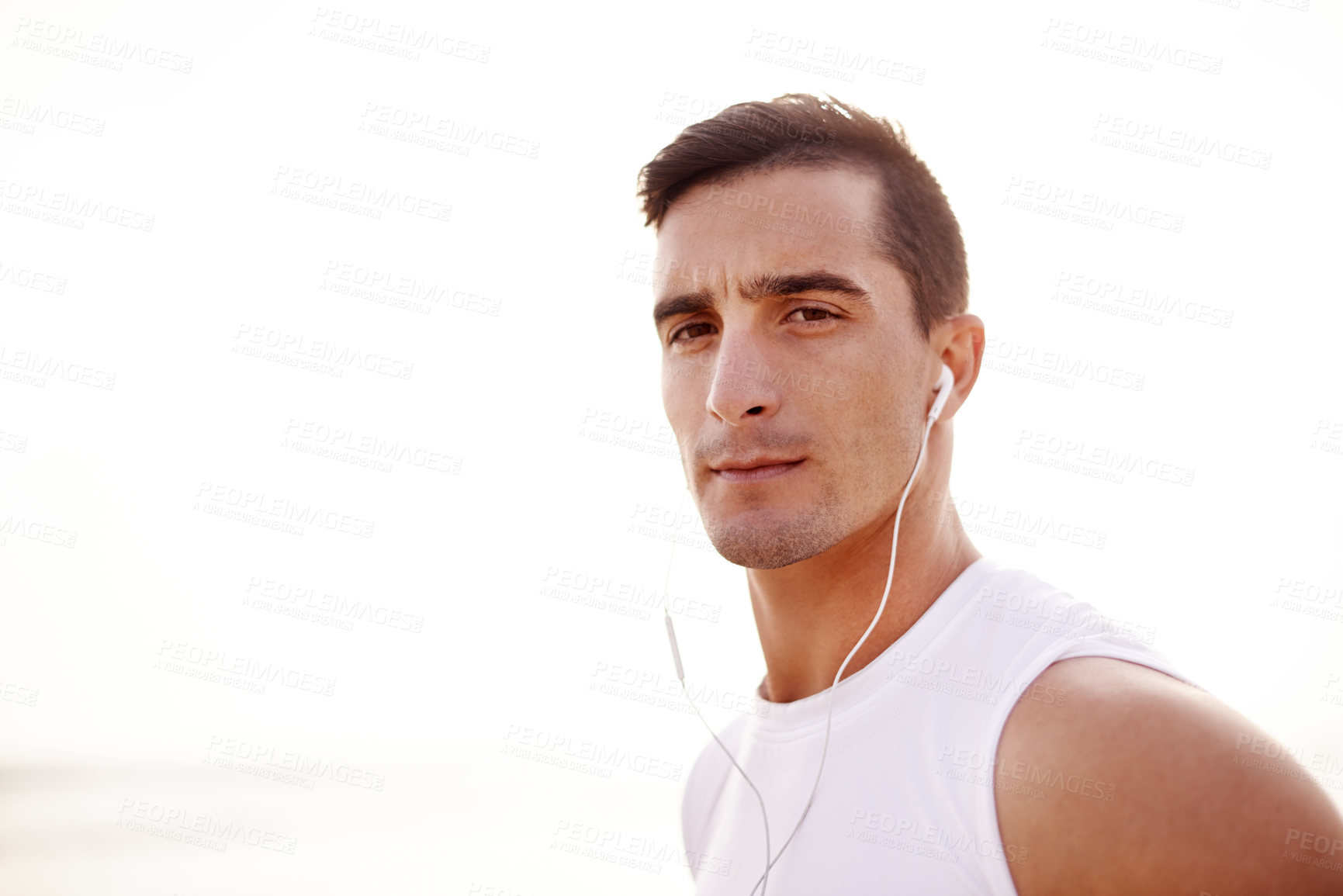 Buy stock photo Earphones, runner and portrait of man at beach for fitness podcast, workout and running. Wellness audiobook, training and health with person in nature for marathon practice, music and cardio