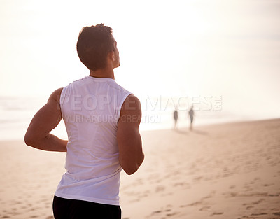 Buy stock photo Fitness, back and man running at beach for wellness, body health and sports workout outdoor at sunset. Ocean, athlete and runner jog for cardio training, lose weight and energy for endurance exercise
