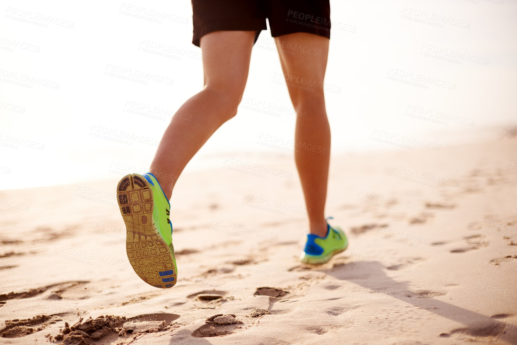 Buy stock photo Man, sand and legs running on beach for fitness, outdoor cardio and sports workout for exercise. Male person, sneakers and athlete for training in nature, ocean and performance on tropical holiday