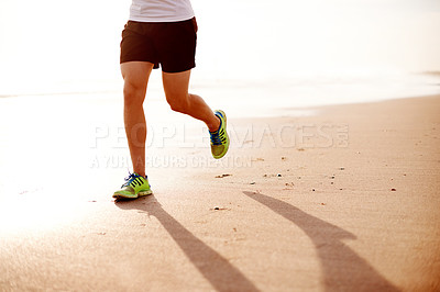 Buy stock photo Man, sand and feet running outdoor for fitness, cardio challenge and sports workout for exercise. Male person, sneakers and athlete for training on beach, ocean and performance on tropical holiday