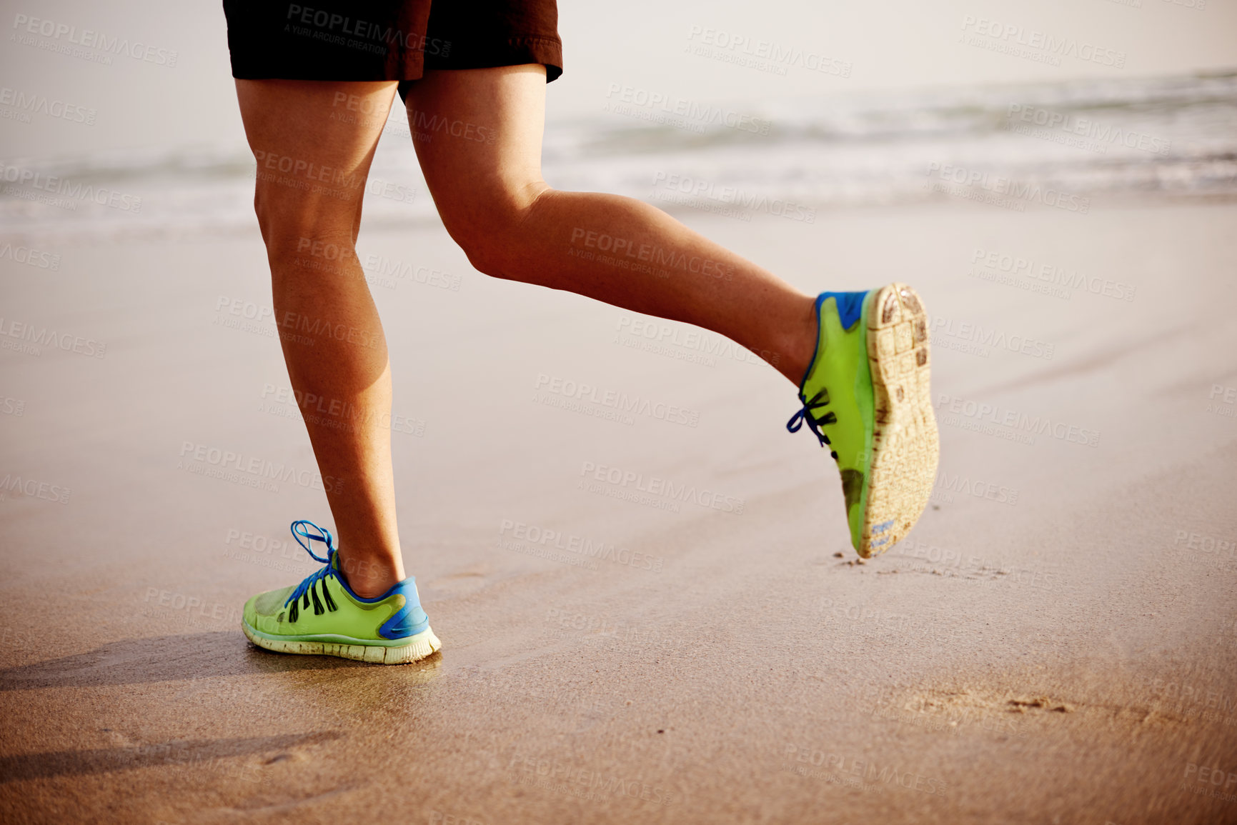 Buy stock photo Man, sand and legs running in nature for fitness, outdoor cardio and sports workout for exercise. Male person, sneakers and athlete for training by water, ocean and performance on tropical holiday