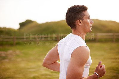 Buy stock photo Fitness, man and running outdoor for workout, body wellness and sports to practice for marathon race. Field, athlete and runner jog for cardio training, exercise and energy for endurance or health