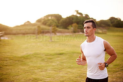 Buy stock photo Fitness, man and running outdoor for exercise, body wellness and sports to practice for marathon race. Field, athlete and runner jog for cardio training, workout and energy for endurance or health