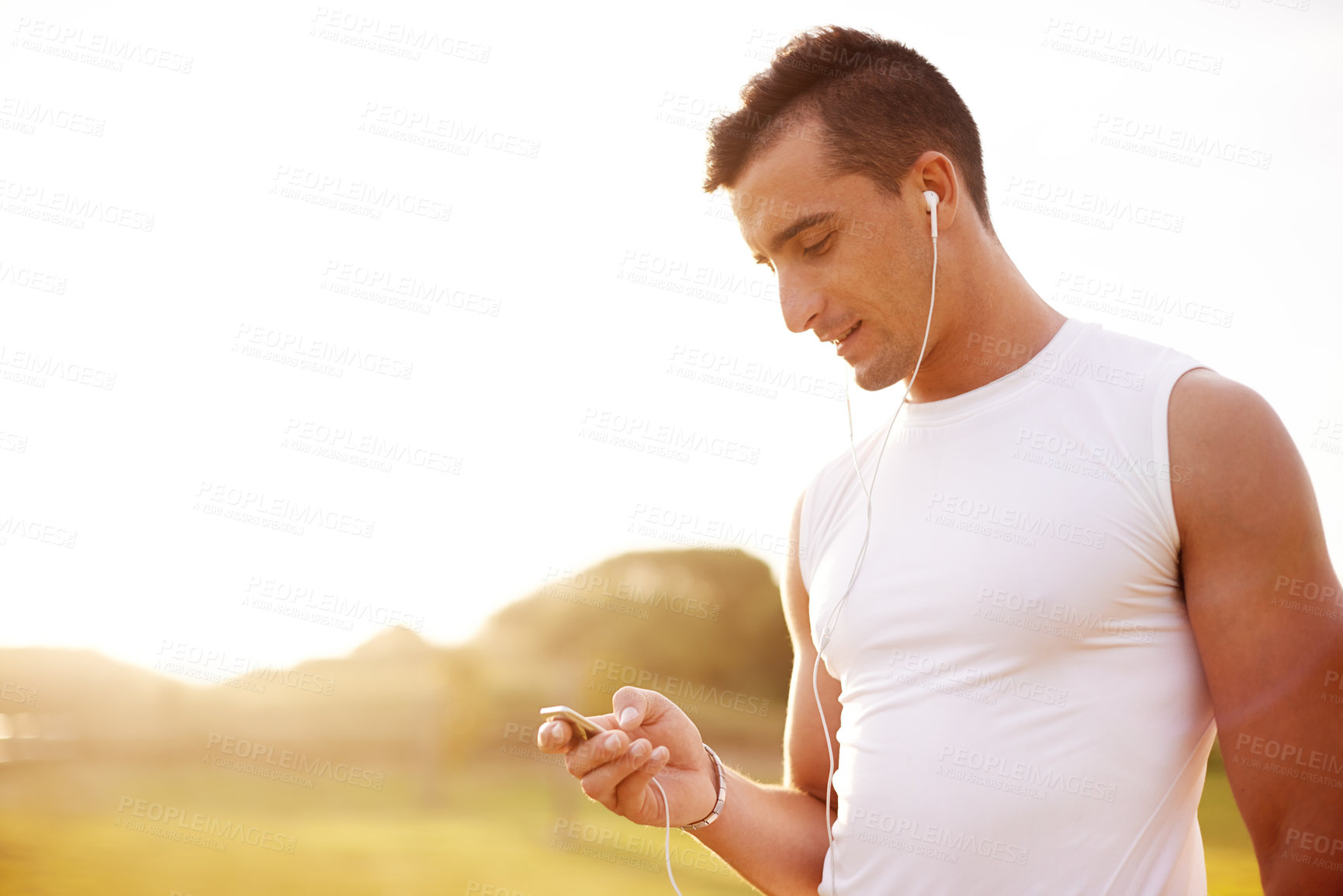 Buy stock photo Outdoor, fitness and man with training, listening to music and motional podcast. Person, athlete and runner with earphones, radio and sound with audio, workout and training routine with progress