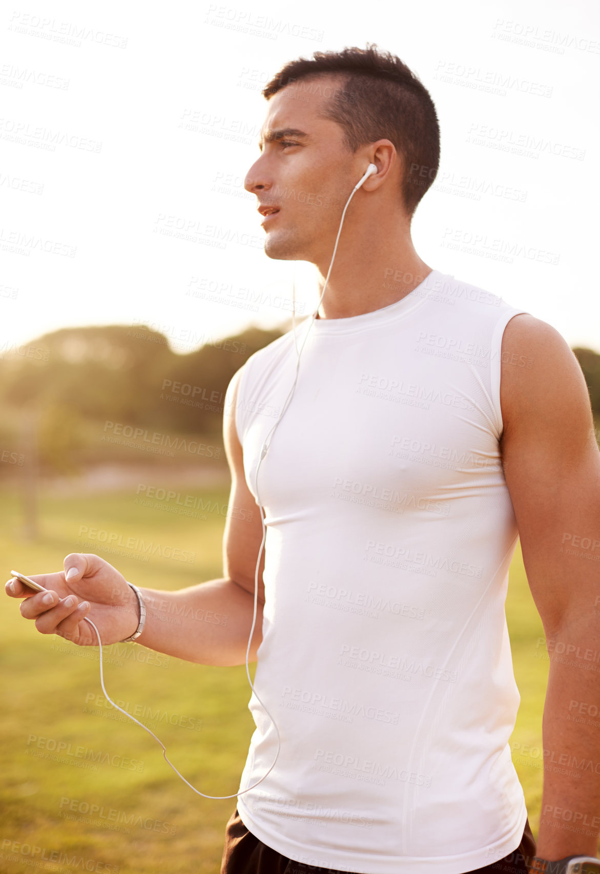 Buy stock photo Sports, earphones and man in nature for running exercise with endurance, speed and race training. Serious, fitness and male athlete with audio tech for music or podcast with outdoor cardio workout.
