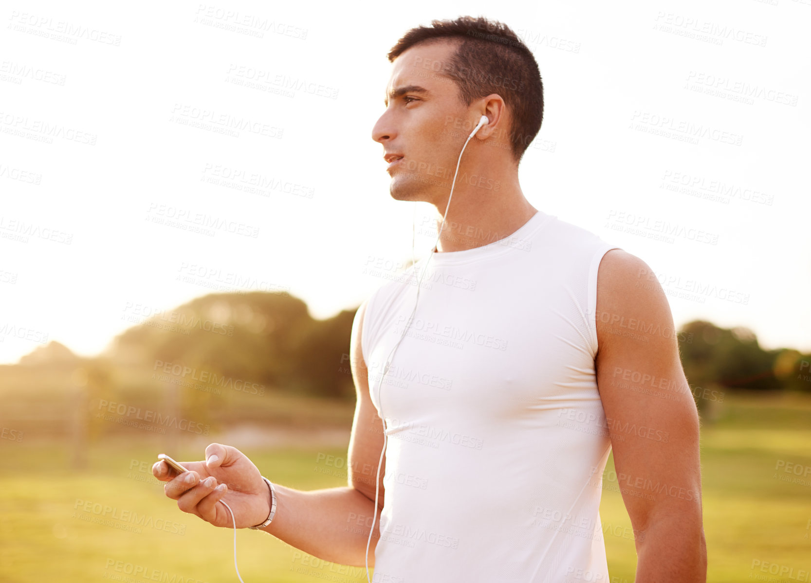 Buy stock photo Fitness, earphones and man in nature for cardio exercise with endurance, speed and race training. Serious, sports and male athlete with audio tech for music or podcast with outdoor running workout.