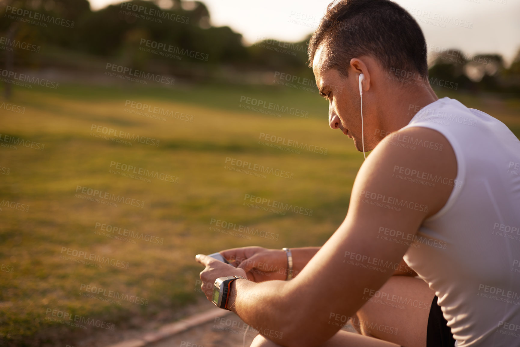 Buy stock photo Outdoor, fitness and man with smartphone, listening to music and motional podcast. Person, athlete and runner with earphones, radio and sound with audio, exercise and training routine with tracker