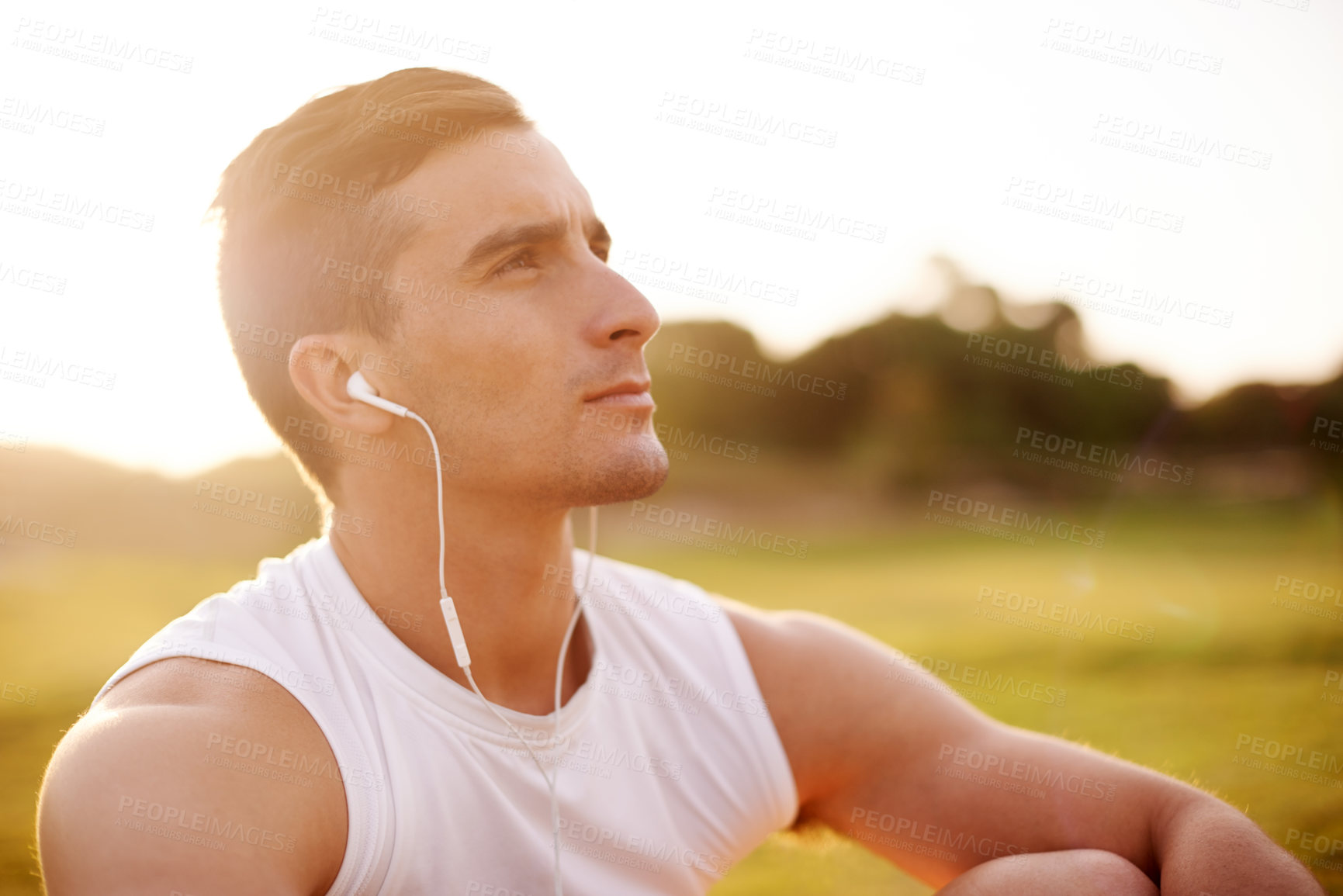 Buy stock photo Music, man and thinking in nature for fitness, break and self reflection podcast for motivation. Athlete, rest and outdoor with earphones for radio, streaming service and audio subscription at sunset