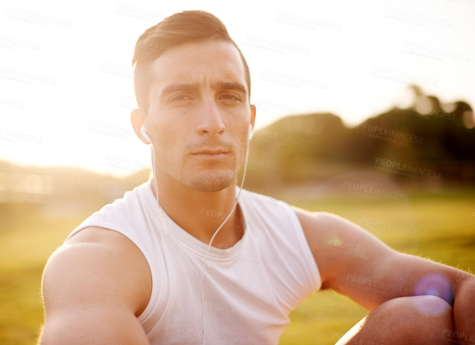 Buy stock photo Fitness, man and portrait with headphones in nature for exercise, break or listening to music. Serious, athlete and sunrise with tech at field for outdoor training playlist, workout or run in morning