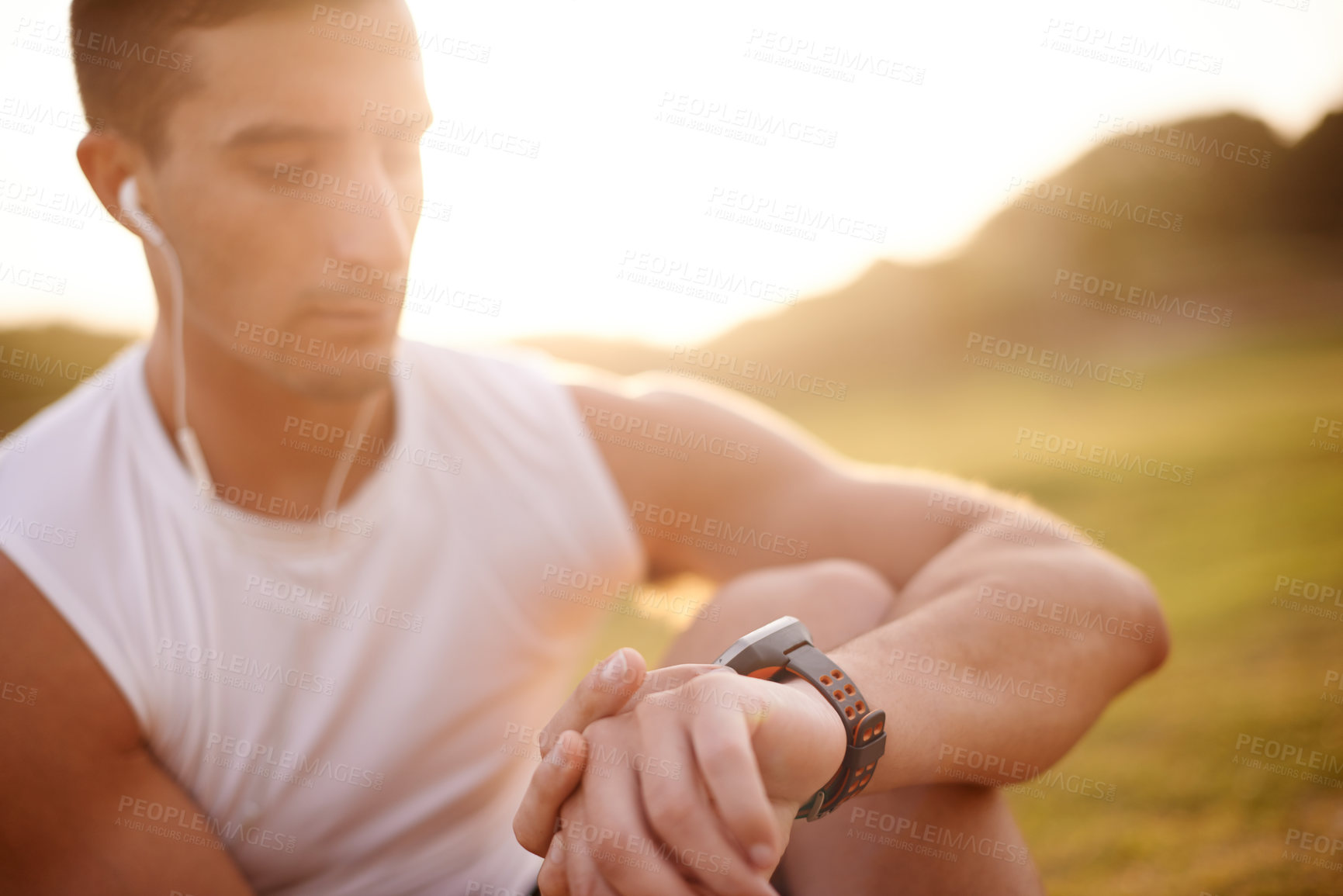 Buy stock photo Smart watch, earphones and man in nature for workout with fitness tracker app for heart rate. Sports, audio tech and male athlete with digital wristband for cardio activity monitoring with running