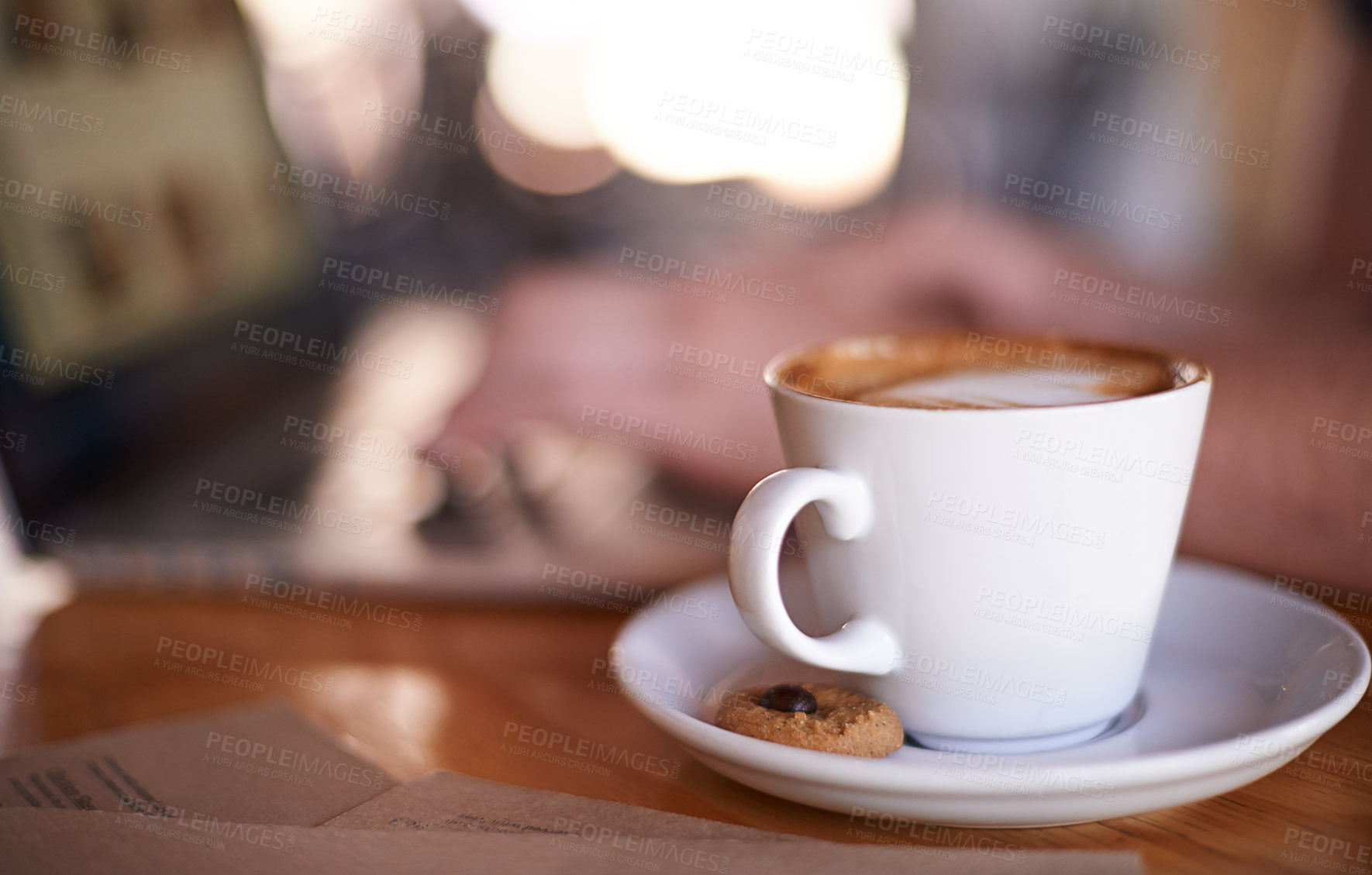 Buy stock photo Coffee, person and relax in restaurant for hospitality, service and laptop for remote work. Mug, customer and latte at cafe table for drink, caffeine and cappuccino at bokeh with tech for networking