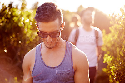 Buy stock photo Fitness, hiking or sunglasses on man in mountains with friends for bonding, exploration or journey. Adventure, exercise and health with group of people walking outdoor in nature for summer outing