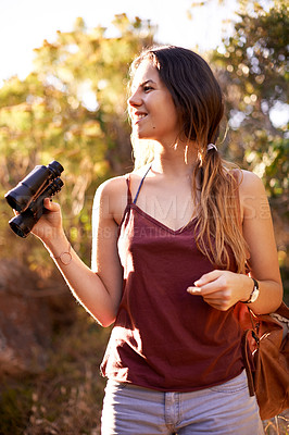 Buy stock photo Travel, trekking and happy woman with binocular in nature for adventure, holiday or bird watching in woods. Thinking, dream and hiking outdoor for vacation, sightseeing or search for forest view