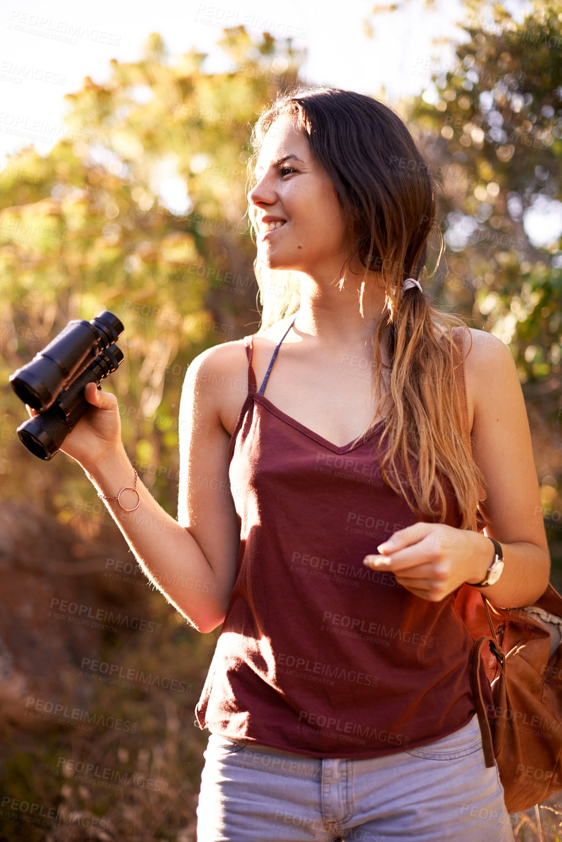 Buy stock photo Travel, trekking and happy woman with binocular in nature for adventure, holiday or bird watching in woods. Thinking, dream and hiking outdoor for vacation, sightseeing or search for forest view