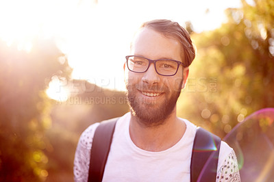 Buy stock photo Portrait, smile and hiking with man in nature for explore, summer vacation and adventure. Health, trekking and travel with person outdoors on path for wellness, fitness journey and eco tourism
