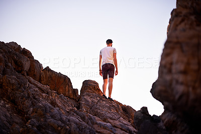 Buy stock photo Back, rock climbing and man on mountain, fitness and adventure for tourist in environment and outdoor. Mockup space, travel and scenery of location in nature, blue sky or person on cliff in Australia