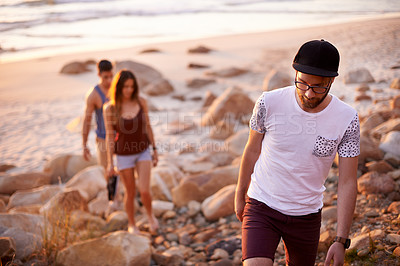 Buy stock photo Man, people and walking on beach outdoor for travel, summer adventure and getaway. Group of friends, trekking and ocean trip of holiday journey, tropical destination and bonding together of gathering