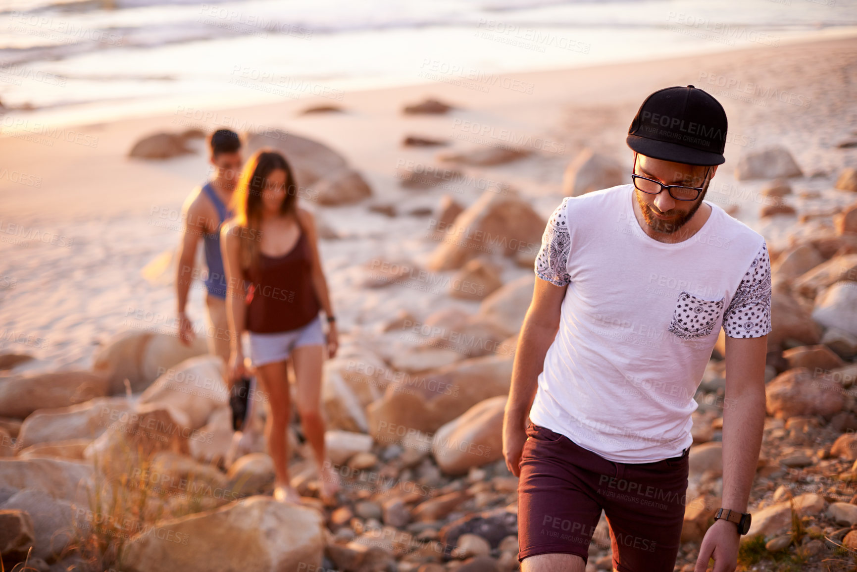 Buy stock photo Man, people and walking on beach outdoor for travel, summer adventure and getaway. Group of friends, trekking and ocean trip of holiday journey, tropical destination and bonding together of gathering
