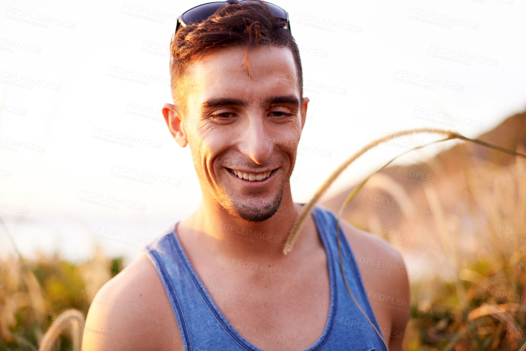 Buy stock photo Smile, travel and hiking with man in nature for explore, summer vacation and adventure. Health, trekking and walking with person outdoors on path for wellness, fitness journey and eco tourism