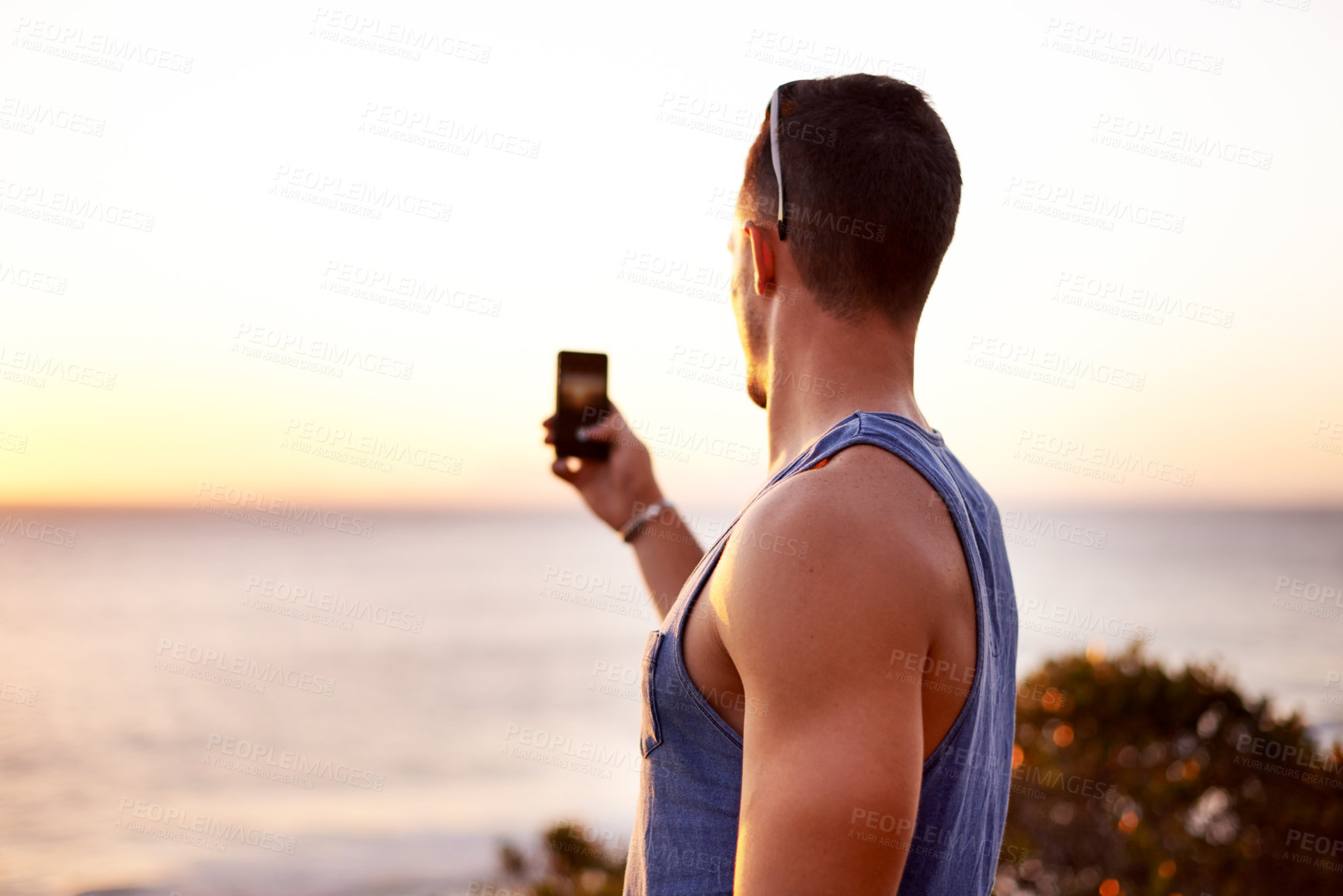 Buy stock photo Beach, picture and man with smartphone, back and capture with vacation, sunset and adventure. Outdoor, person and guy with cellphone, travel and summer holiday with social media, explore and Bali