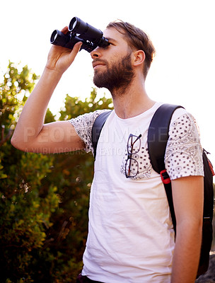 Buy stock photo Travel, trekking and man with binocular in nature for adventure, holiday or bird watching in woods. Lens, tourism and hiking outdoor for vacation, sightseeing or search for discovery with forest view