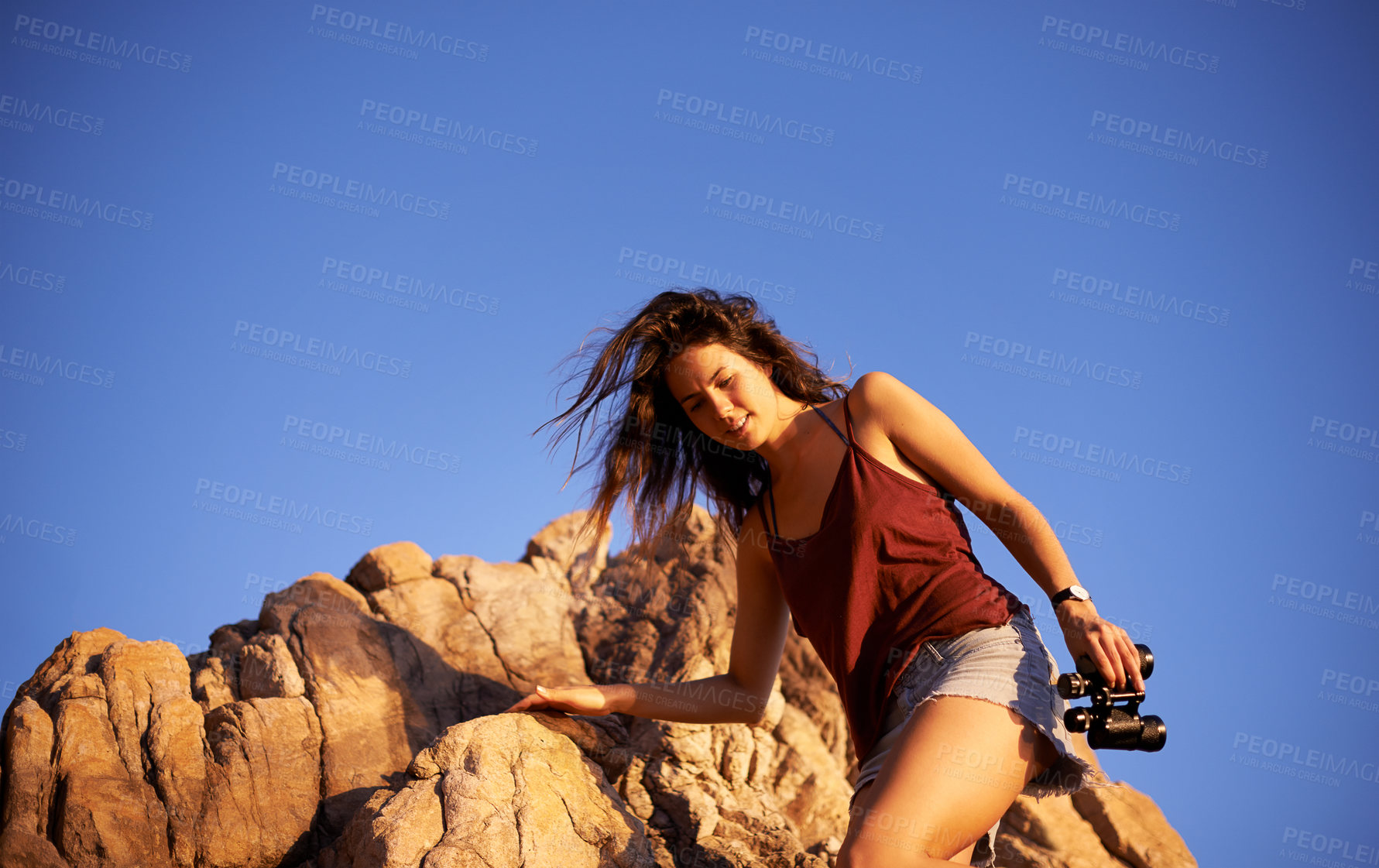Buy stock photo Travel, woman and rock climbing for adventure, holiday or mockup space on blue sky. Outdoor, hiking or trekking on mountain for vacation, explore or walking with binoculars for view in nature at peak