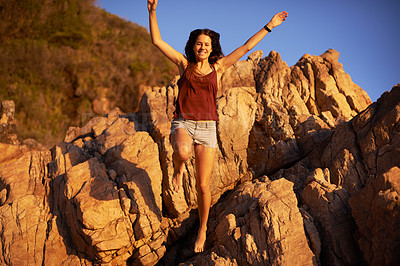 Buy stock photo Freedom, hiking and jump with woman in mountains for adventure, energy or journey outdoor. Exercise, fitness and smile of happy person in nature with hands raised for celebration, health or wellness