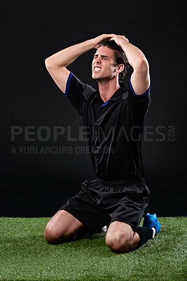 Buy stock photo Field, soccer player and man in grass, frustrated and fail in game, stress and upset on ground and outdoor. Black background, sad and athlete with hands, unhappy or  shouting of person and football