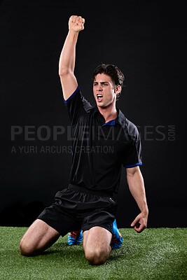 Buy stock photo Field, soccer player and man in grass, celebration and win in game, excited and cheering on ground and outdoor. Black background, happy and athlete with hands, fist or shouting of person and football