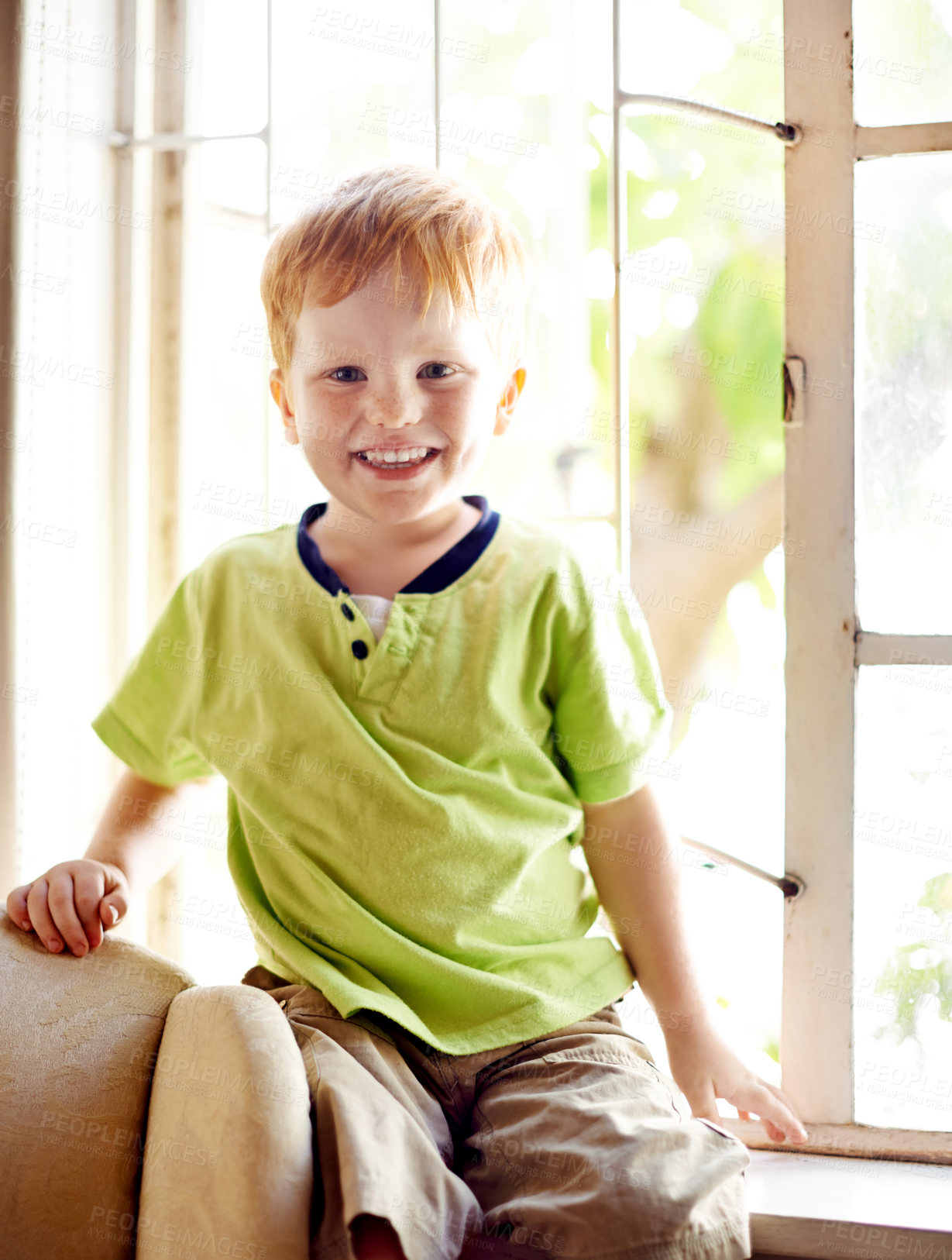 Buy stock photo Portrait, happy kid and boy in home for relax, weekend and break in living room. Cute, young child and smile in house to chill by window, adorable and growth for development on sofa in New Zealand