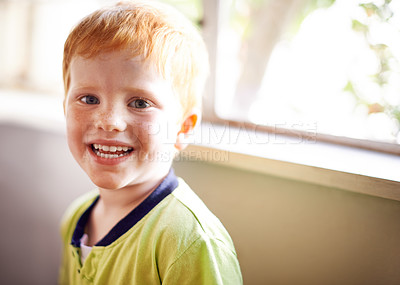 Buy stock photo Portrait, kid and boy with smile at house for weekend break, playful expression and growth development. Happy, child and face with red hair for childhood innocence, curious and comfortable in lounge