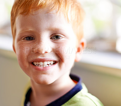 Buy stock photo Portrait, child and boy with smile at house for weekend break, playful expression and growth development. Happy, kid and face with red hair for childhood innocence, curious and comfortable in lounge