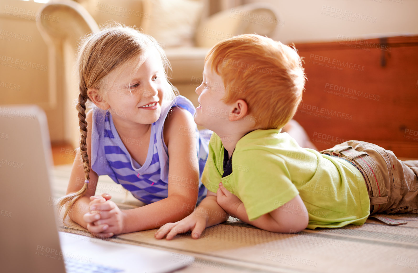 Buy stock photo Relax, family and children in living room, talking and smile for conversation in home, love and siblings. House, brother and chat with sister in lounge, happy and boy with girl on floor by laptop